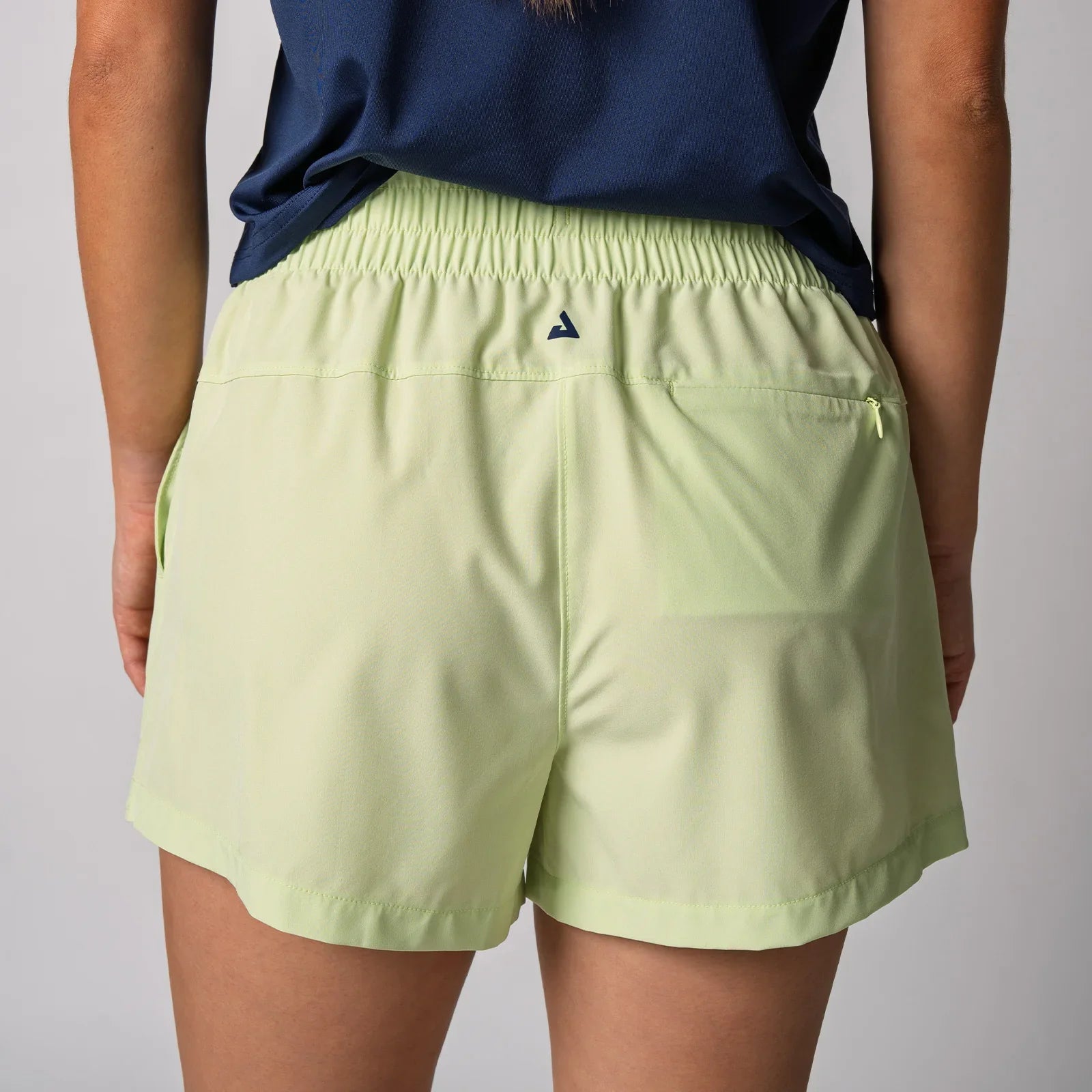 Light green athletic shorts with elastic waist and back pocket, ideal for pickleball or tennis